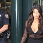  Kim Kardashian in sheer black blouse and tight fishtail skirt